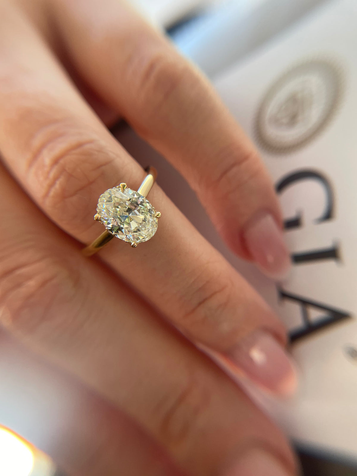 Oval diamond solitaire engagement ring in yellow gold
