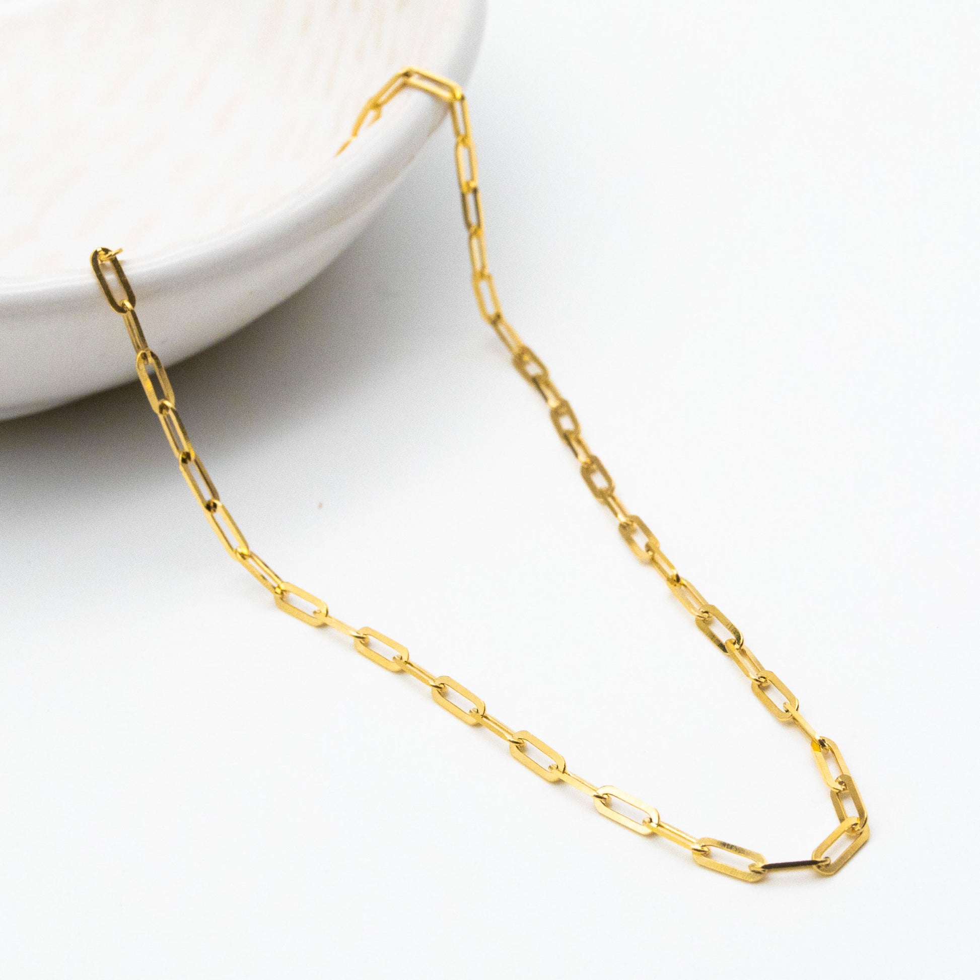 2.3mm paperclip chain in 9ct yellow gold worn around the neck